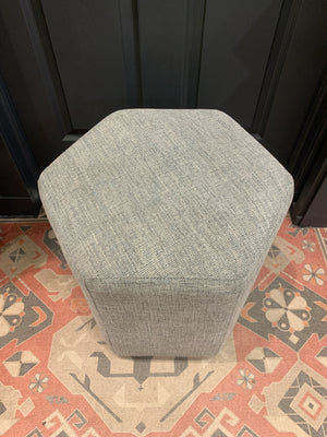 Grey hexagonal ottoman.
